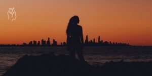 Femme face à un coucher de soleil